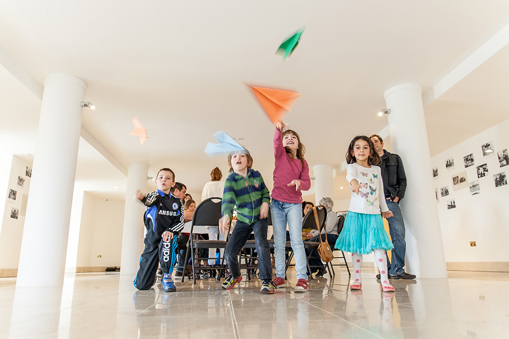 Children throwing paper aeroplanes in the Learning Centre